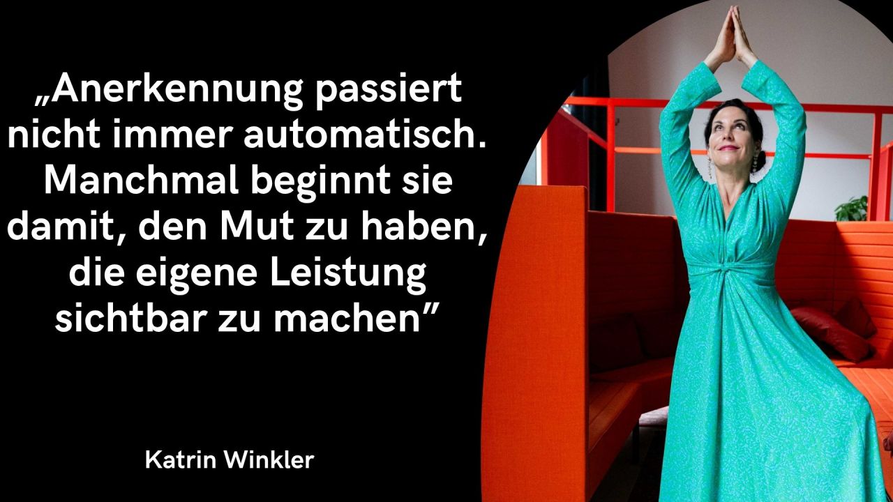 Auf der linken Seite befindet sich eine schwarze Fläche mit folgendem Zitat in großer, weißer Schrift: „Anerkennung passiert nicht immer automatisch. Manchmal beginnt sie damit, den Mut zu haben, die eigene Leistung sichtbar zu machen“ Unten links steht in etwas kleinerer, weißer Schrift der Name Katrin Winkler. Die rechte Seite zeigt in einem abgerundeten, geschwungenen Ausschnitt ein Ganzkörperfoto: Es zeigt Katrin Winkler in einem auffälligen, langen, türkis- bzw. smaragdgrünen Kleid mit langen Ärmeln. Sie streckt beide Arme hoch über den Kopf, sodass sich ihre Handflächen berühren – eine aufrechte, gestreckte Pose. Sie blickt dabei lächelnd nach oben. Sie befindet sich in einer modernen Indoor-Umgebung vor einer leuchtend orangefarbenen Sitznische bzw. Raumteiler-Couch.
